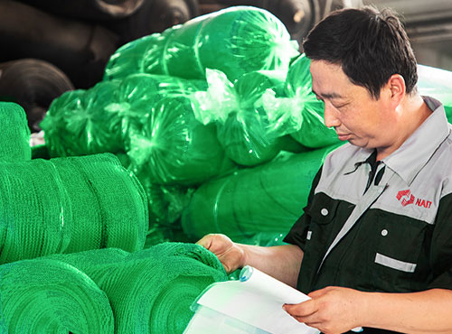 An inspector is checking final net quality