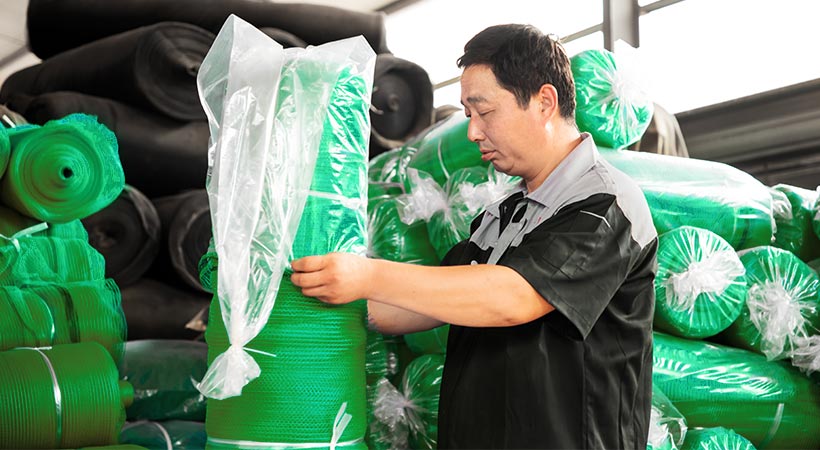 A worker is packaging net